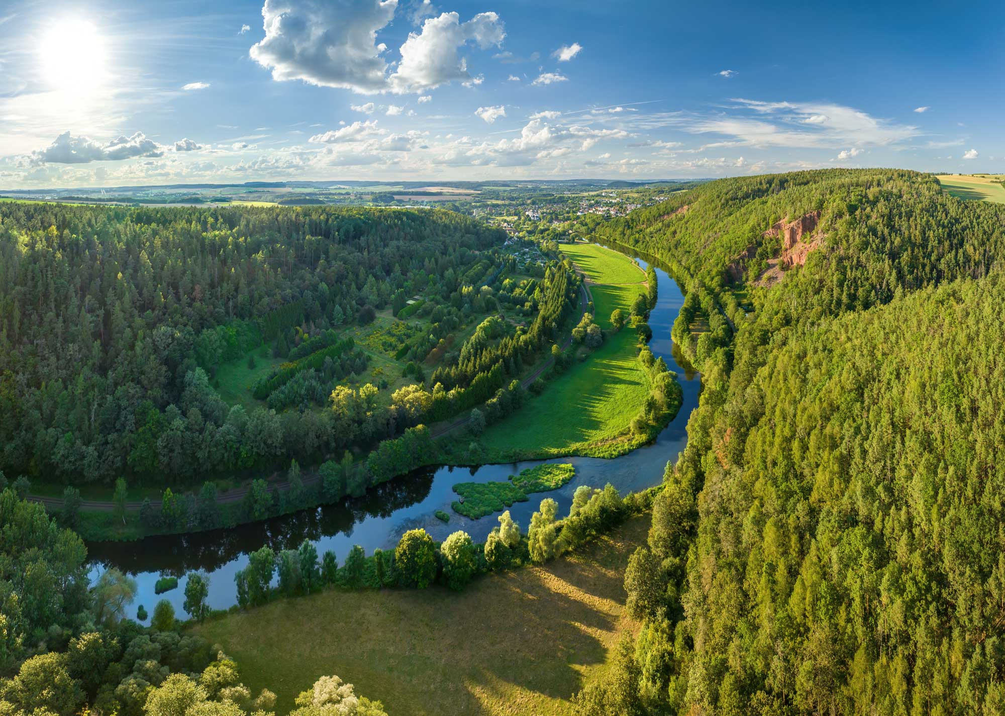Luftaufnahme von einem Fluss, umgeben von Wald
