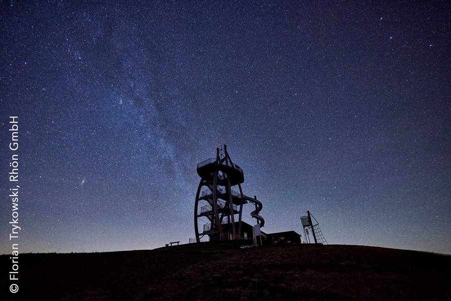 Vor dem Sternenhimmel steht ein Aussichtsturm. 